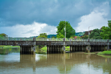 Fototapeta na wymiar Historical road bridge over Taruheru River on a stormy day. Gisborne, North Island, New Zealand