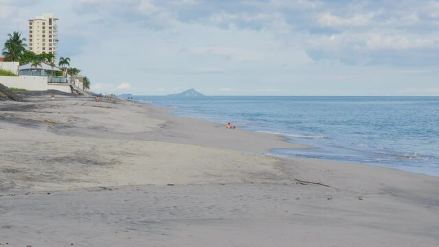 Two Children playing on the beach.  Coronado, Panama. Daytime.