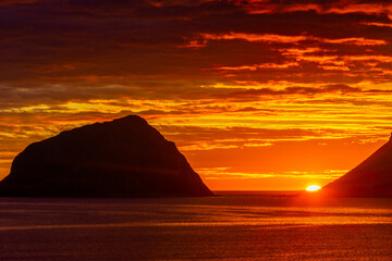 Fototapeta na wymiar Incredible midnight sunset over the sea of Vik beach, Lofoten Islands, Norway