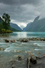 Fototapeta na wymiar Landscape of the Lovatnet glacial lake with turquoise crystal clear water, Norway