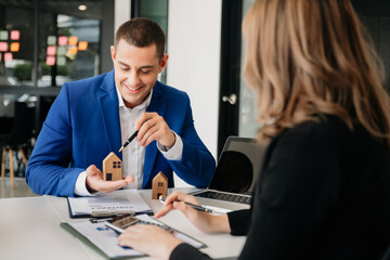 uying a home or insurance deal, an insurance agent pointing a pen to those interested in renting a house, a contract, signing an Home buying agreement