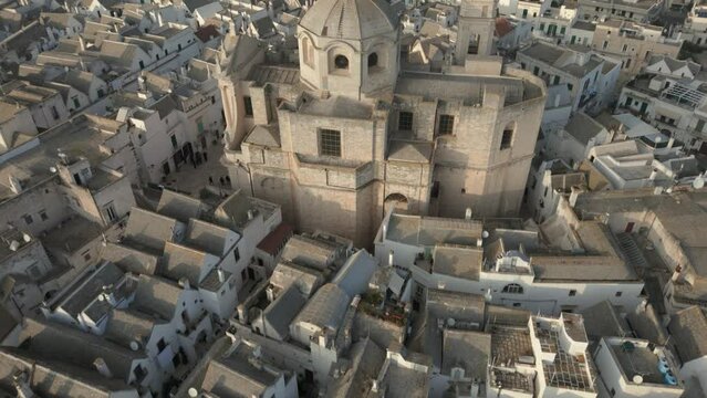 Drone camera revealing medieval temple San Giorgio Martire in the city of Locorotondo