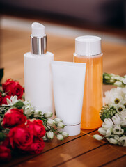 Set of cosmetic product on nature background. Colored containers with cosmetic