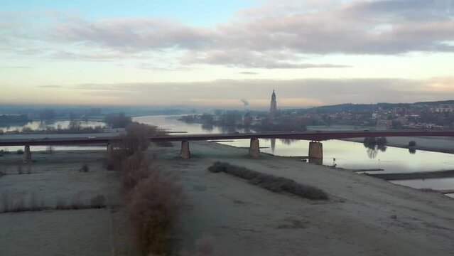 Local Dutch Landscape of a bridge at sunrise by a village.