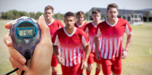 Composite image of close up of a hand holding a timer on a white background