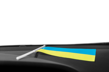 Ukrainian flag on glass inside the car on white