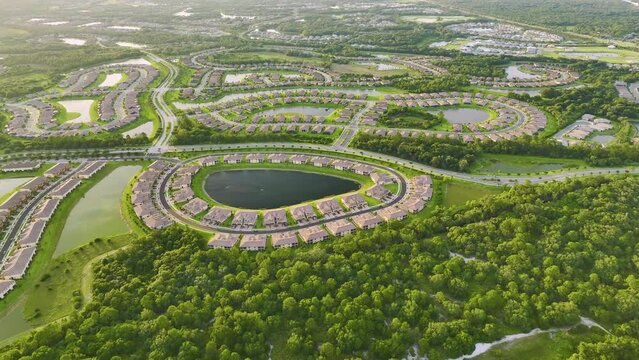 View from above of densely built residential houses near retention ponds in closed living clubs in south Florida. American dream homes as example of real estate development in US suburbs