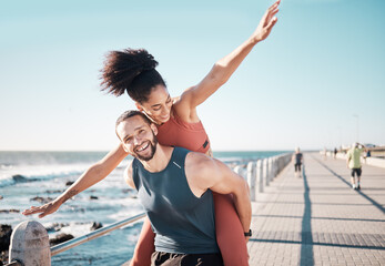 Beach, fitness and couple piggyback in summer enjoying holiday, vacation and quality time on...