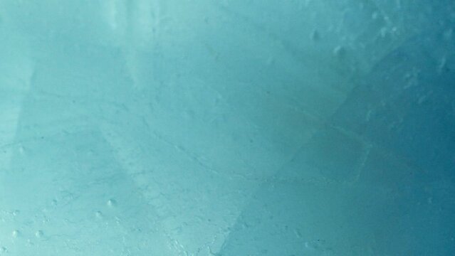 Blue crushed ice texture background on water surface with underwater lights
