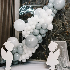 Birthday decorations - arch, balloons, and decor for little baby party on a wall background....