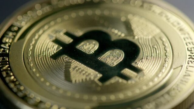 Detailed close-up shot over golden bitcoin cash coin; shadow pass over