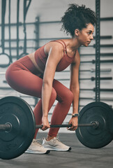Gym, barbell exercise and black woman doing muscle fitness performance for body health, strength...