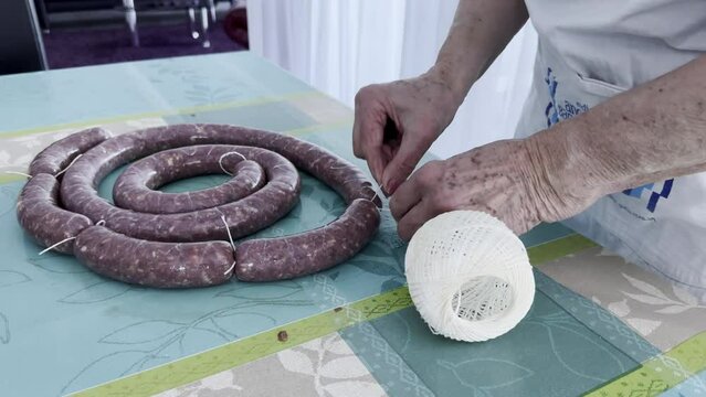 Freshly made sausages are tied with string to form small sausages. Ready for drying. Home recipe
