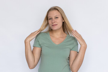 Fototapeta premium Nice woman looking at camera. Young female model throwing hair back. Portrait, studio shot, playfulness concept