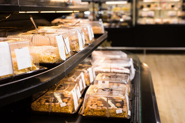 variety of sweet delicious cakes on the shop window of a cafe