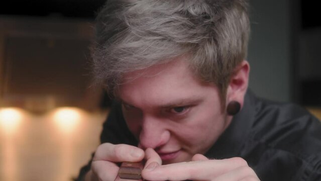 Evil stare at chopping knife and camera while touching blade by young crazy psychopath male chef in elegant black shirt with an alternative look and tattoo
Modern, fancy looking kitchen Slow Mo Dolly