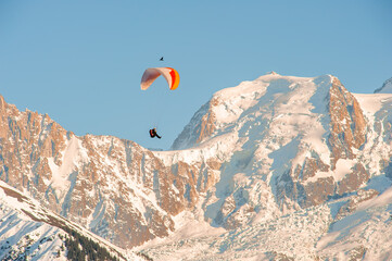 Fototapeta na wymiar Paragliding over snow covered mountains 2