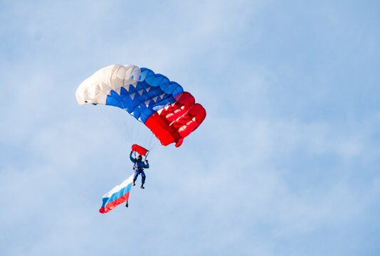 Low angle view of paraglider paragliding with Russian Flag against sky