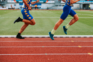 Determined male athletes legs pushing through the long distance race. Perfect for promoting perseverance, endurance, and physical fitness