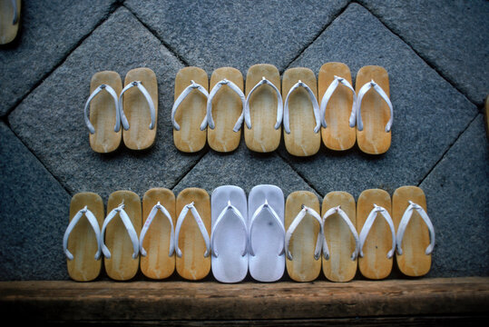 Several pairs of slippers placed on a wooden table, Japan, Asia.