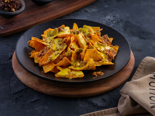Buffalo chicken wings with beer, french fries on wooden board. fast food 
