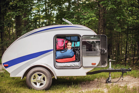 Woman peeking out of camper trailer