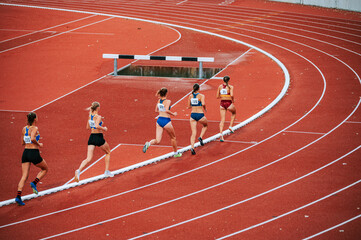 Powerful image of female athletes competing in long distance race. Suitable for fitness,...