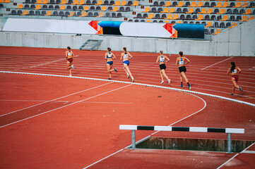 Determined female athletes pushing through long distance race. Great for promoting perseverance,...