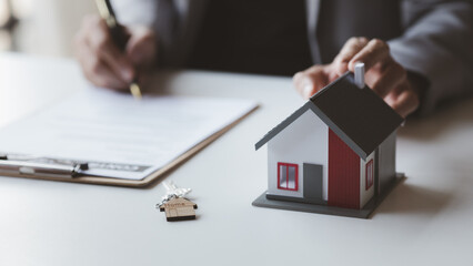 A rental company employee is calculating the cost for the customer to agree to sign a rental contract, explaining the rental terms and conditions. Home and real estate rental ideas.