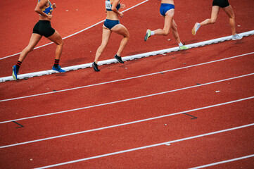 Determined female athletes legs pushing through the long distance race. Perfect for promoting perseverance, endurance, and physical fitness