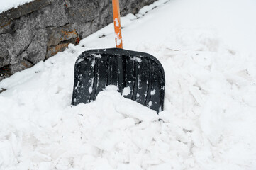 Black shovel for snow close-up. snow cleaning.