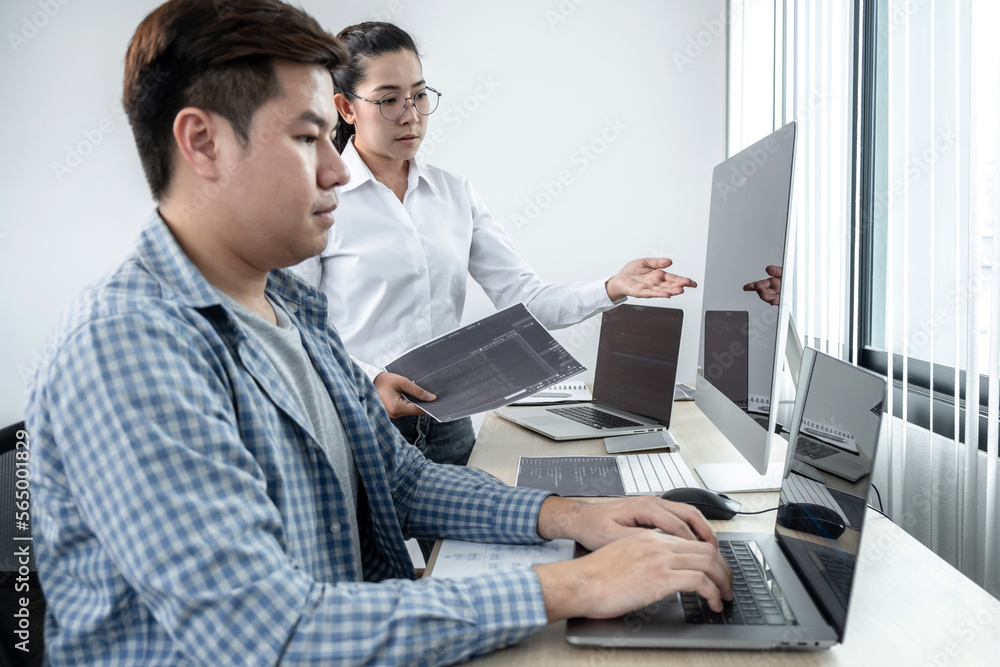Leinwandbilder Team of two professional programmers working on website projects in software development on the desktop computer and making coding and typing data code password security in office