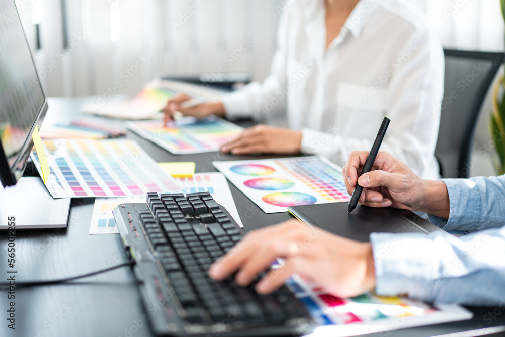 Poster two creative graphic designer team working on color selection and drawing on graphic tablet, color s