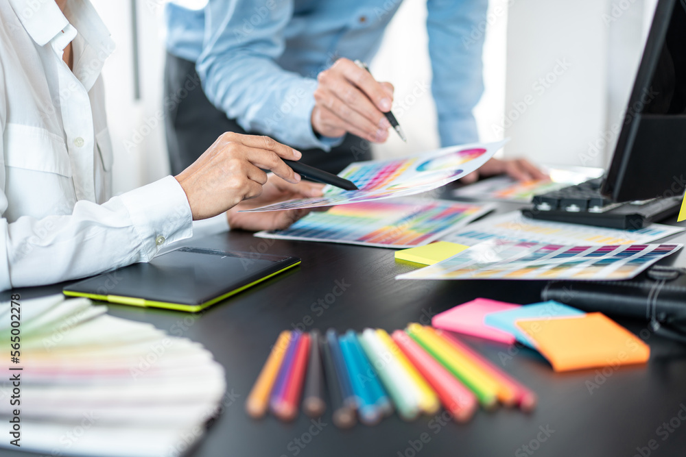 Poster Team of creative graphic designer working on color swatch samples chart for selection coloring in inspiration to create new collection at workplace