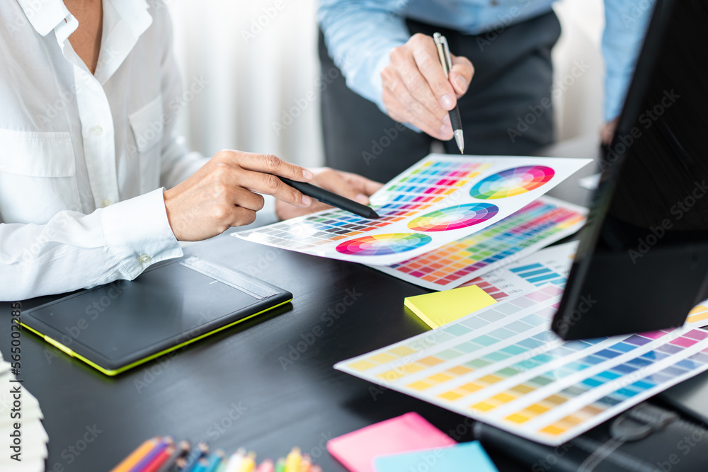 Poster two creative graphic designer team working on color selection and drawing on graphic tablet, color s