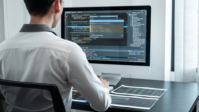 Professional programmer working on website project in software development on the desktop computer, making coding and typing data code password security