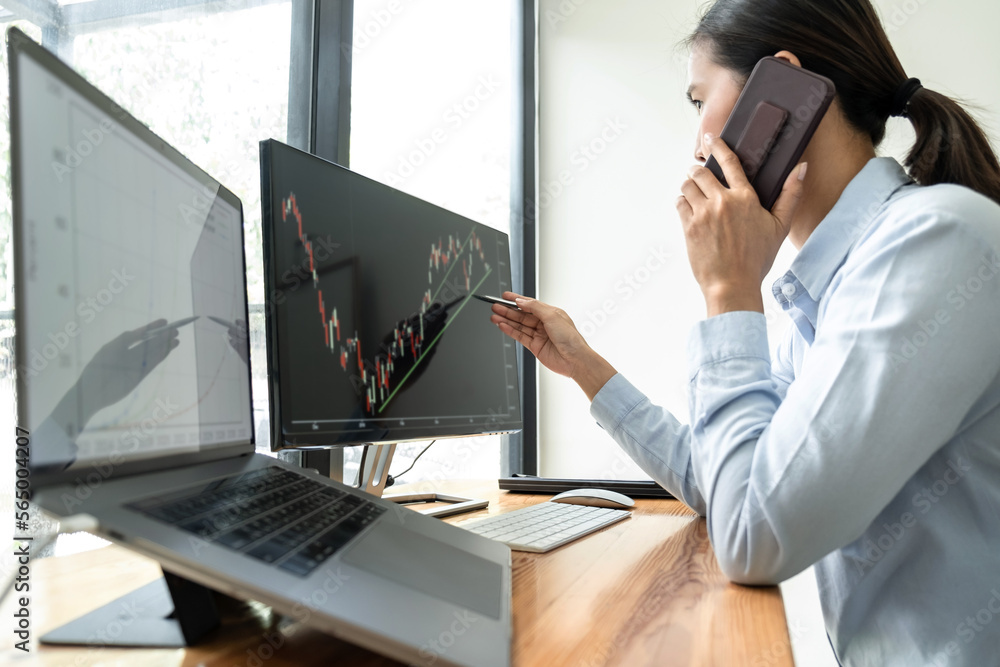 Poster businesswoman investor having planning and analyzing graph data with display screen the data present