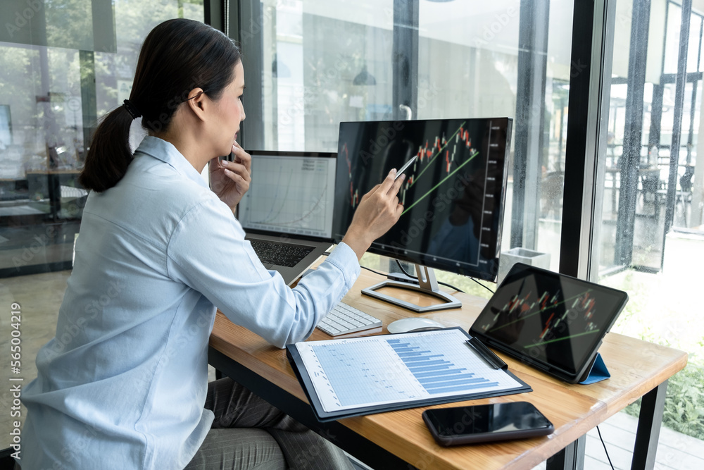 Poster businesswoman investor having planning a new project and analyzing graph data with display screen th