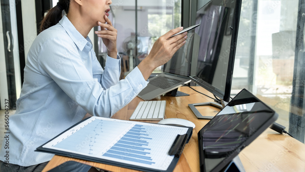 Poster businesswoman investor having planning and analyzing graph data with display screen the data present