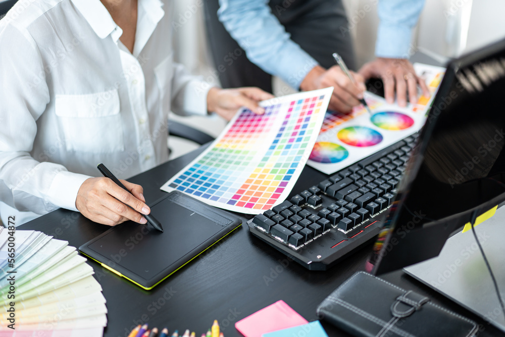 Poster two creative graphic designer team working on color selection and drawing on graphic tablet, color s