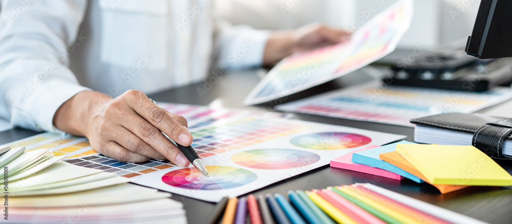 Poster young creative graphic designer working on color selection and d