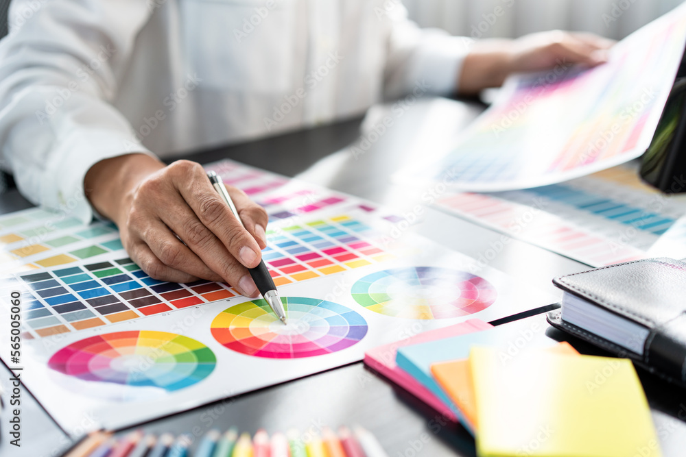 Aufkleber Young creative graphic designer working on color selection and drawing on graphics tablet at workplace, Color swatch samples chart for selection coloring in inspiration to create new collection
