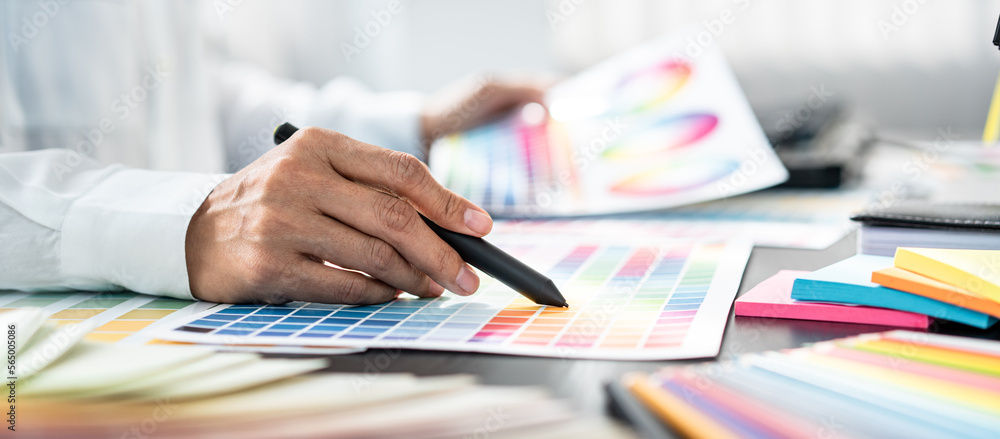 Aufkleber Young creative graphic designer working on color selection and drawing on graphics tablet at workplace, Color swatch samples chart for selection coloring in inspiration to create new collection