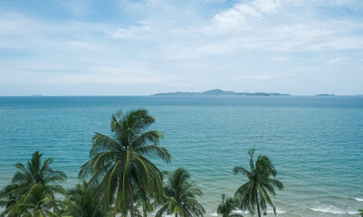 Fototapeta na wymiar Sunny day on tropical sea. Seascape and island view. Palm tree on summer beach.