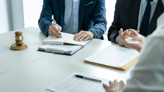 Businesspeople and Male lawyer consult and conference having team meeting with the client at a law firm in office, Law and Legal services concept
