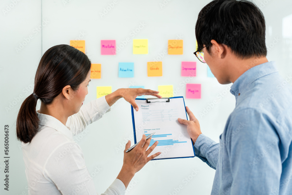 Poster two business executive team holding and taking notes keyword on board wall to brainstorm about a new