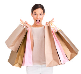 An attractive woman looking excited while holding up shopping bags isolated on a PNG background.