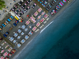 Bird's-eye view of Bodrum beach and the tables on the beach with drone