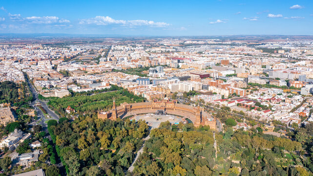 Aerial view of Spanish city of Seville in Andalusia region on river Guadaquivir overlooking Plaza de Espana and Parque Maria Luisa sunny day summer