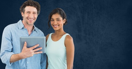 Caucasian man and african american woman with digital tablet against copy space on blue background